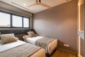 Posteľ alebo postele v izbe v ubytovaní Apartamentos Core Suites Valencia