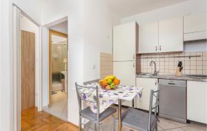 a kitchen with a table with a bowl of fruit on it at Awesome Apartment In Viskovo With Kitchen in Viskovo