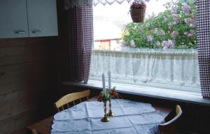 a dining room table with a white curtain and a window at Holiday Home Sørbøvåg Sandnes in Sandnes +5 photos