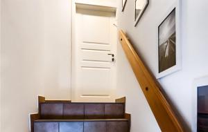 a stairway with a white door and a stair case at Cozy Apartment In Emmelsbll-horsbll With Wifi in Emmelsbüll-Horsbüll