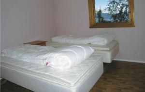 three mattresses sitting in a room with a window at Holiday Home Balestrand Stokkabø in Tuve