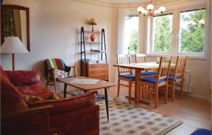 a living room with a table and a dining room at Awesome Home In Lttorp With Wifi in Löttorp