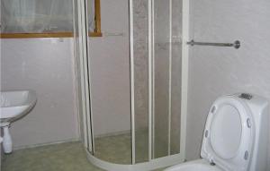 a bathroom with a shower and a toilet and a sink at Holiday Home Balestrand Stokkabø in Tuve +2 photos