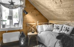 a bedroom with a bed in a wooden room at 3 Bedroom Lovely Home In Vikanes in Eikemo