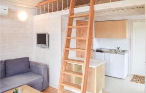 a ladder leading up to a loft bed in a room at Cozy Home In Hagby With Kitchen in Hagby