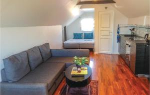a living room with a couch and a table at 0-Bedroom Apartment In Klintehamn in Klintehamn