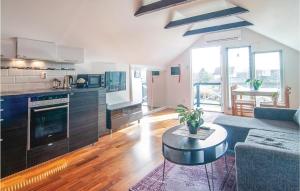 a kitchen and living room with a couch and a table at Cozy Apartment In Klintehamn With Wifi in Klintehamn