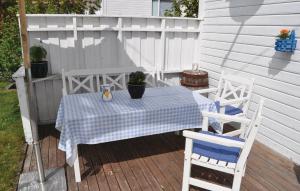 a table and two chairs sitting on a deck at Holiday Home Skudeneshavn Kvednadalen in Skudeneshavn