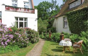 a garden with a table and chairs in front of a house at Nice Apartment In Lbeck With Kitchen in Lübeck
