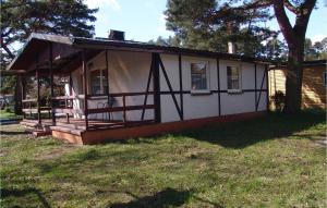 a small house with a porch on a yard at Amazing Home In Jaroslawiec With Outdoor Swimming Pool in Jarosławiec