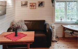 a living room with a leather couch and a table at Nice Home In Valen With Wifi in Valen