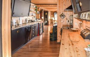 a kitchen with wooden floors and a wooden counter top at 3 Bedroom Cozy Apartment In l in Skarsgård