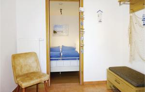 a bedroom with a mirror and a chair and a bed at Awesome Home In Insel Poel in Insel Poel +18 photos