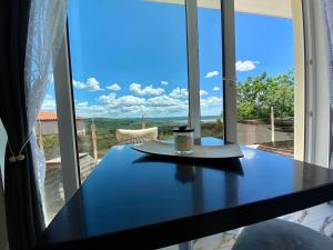 a table with a candle on it in front of a window at Apartma Hill Portorose in Portorož