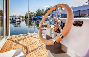 a steering wheel of a boat on a dock at Lovely Ship In Hennigsdorf With Lake View in Hennigsdorf