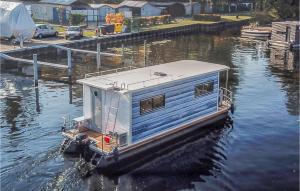 a house boat is docked in the water at Lovely Ship In Hennigsdorf With Lake View in Hennigsdorf