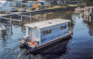 a house boat is docked in the water at 1 Bedroom Stunning Ship In Hennigsdorf in Hennigsdorf +1 photo