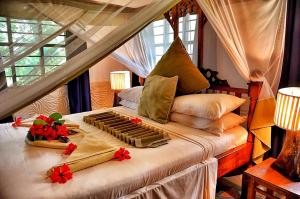 a bedroom with a bed with flowers on it at Pongwe Beach Hotel in Pongwe +37 photos