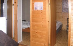 a door leading into a room with a bedroom at Raaen Hytteutleige 1 in Utne