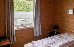 a bedroom with a bed and a window with a view of the water at Gorgeous Home In Etne With Wifi in Etnesjøen