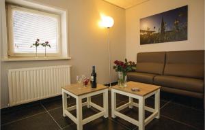 a living room with a couch and a table with a bottle of wine at Lovely Home In Retranchement With Wifi in Retranchement
