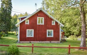 a red barn with a tree in front of it at Awesome Apartment In Rönneshytta in Rönneshytta +19 photos
