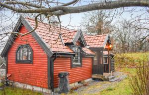 a small red house with a red roof at Beautiful Home In Asarum in Asarum