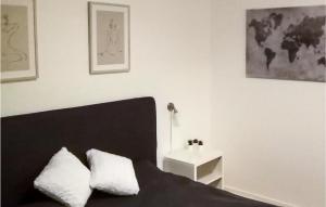 a bedroom with a black bed with two white pillows at Nice Apartment In Hyltebruk With 2 Bedrooms And Wifi in Hyltebruk