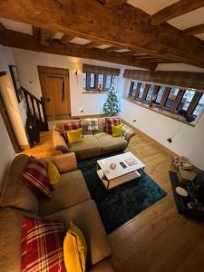 a living room with a couch and a christmas tree at The Horners - Log burner, Cheshire Village, Parking, Walks, Aga, dogs in Prestbury