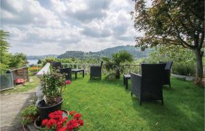 a row of tables and chairs on a lawn with flowers at Cozy Apartment In Piran With Wifi in Piran +12 photos