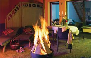 a fire pit in a room with a table at Lovely Home In Pinnow With Kitchenette in Petersberg
