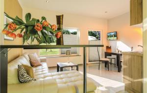 a living room with a white couch and a table at Lovely Home In Pinnow With Kitchenette in Petersberg +5 photos