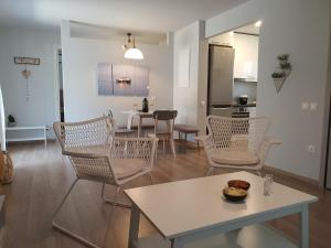 a living room with chairs and a table and a kitchen at Jasmine Villa in Vari