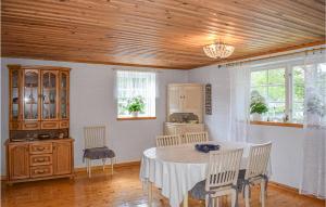 a kitchen with a table and chairs in a room at Cozy Home In Högsby With Sauna in Aboda