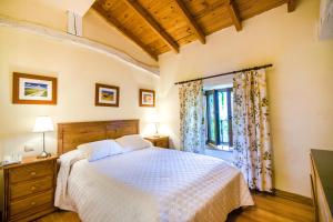 Postel nebo postele na pokoji v ubytování Hotel Palacio Garcia Quijano