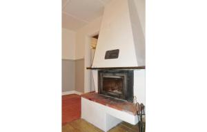 a living room with a fireplace in the corner at Holiday Home Björkvägen Höör in Höör