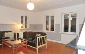 a living room with a couch and a table at Holiday Home Björkvägen Höör in Höör