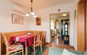 a dining room with a red table and chairs at Nice Home In Winten With 1 Bedrooms And Internet in Winten