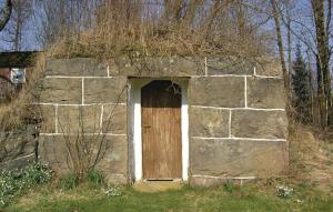 an old stone building with a wooden door at Stunning Home In Östra Frölunda in Östra Frölunda