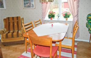 a dining room with a table and chairs at Stunning Home In Östra Frölunda in Östra Frölunda