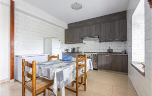 a kitchen with a table and chairs and a kitchen with a stove at Stunning Home In Fisterra With Kitchen in Fisterra