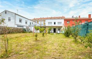 a yard with buildings in the background at Stunning Home In Fisterra With Kitchen in Fisterra