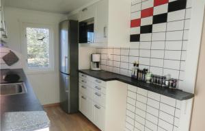 a kitchen with black and white tiles on the wall at Stunning Home In Lttorp With Wifi in Löttorp