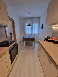 a kitchen with a table in the middle of a room at Golden Fields Apartment near the Old Town in Kotor
