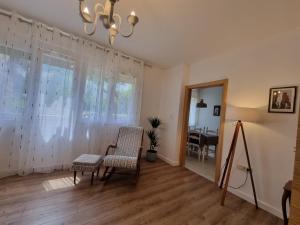 a living room with a table and chairs and a chandelier at Golden Fields Apartment near the Old Town in Kotor