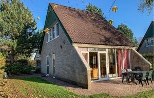 a small house with a patio and a table at 3 Bedroom Nice Home In Vlagtwedde in Vlagtwedde