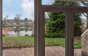 an open glass door with a view of a lake at 3 Bedroom Nice Home In Vlagtwedde in Vlagtwedde