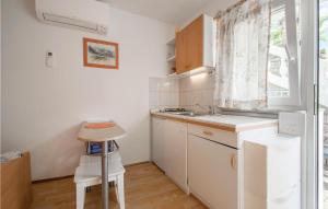 a kitchen with white cabinets and a sink and a window at Nice Apartment In Piran With Wifi in Piran
