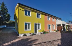 a yellow and orange house on a brick street at Nice Apartment In Piran With Wifi in Piran