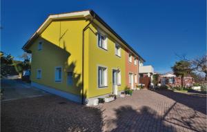 a yellow and green house on a street at Nice Apartment In Piran With Wifi in Piran